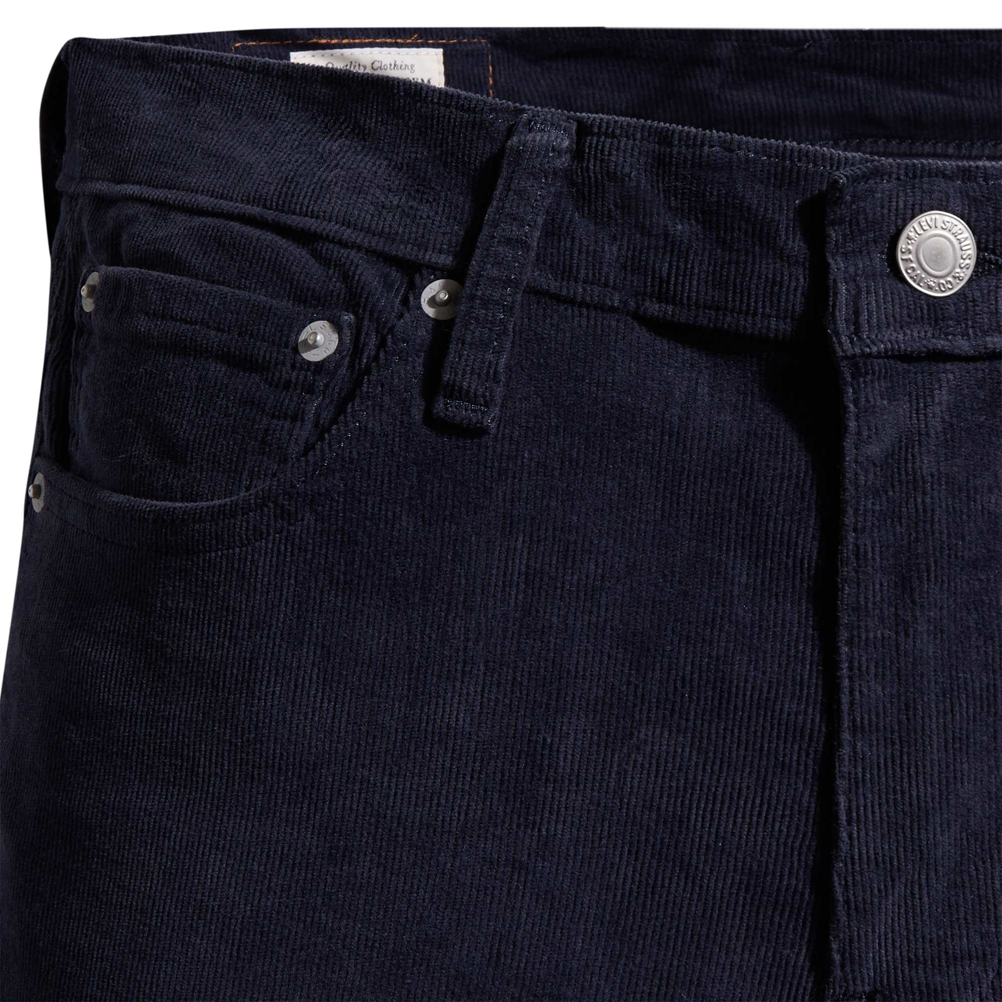 A close-up of the waistband and front pocket detail of navy corduroy trousers.
