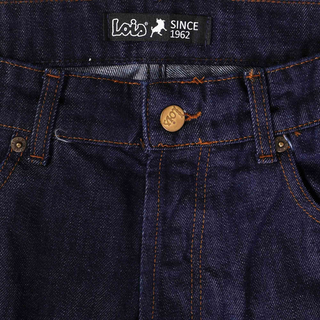 Close-up of the waistband of men's dark blue jeans showing the gold button fly and brand.