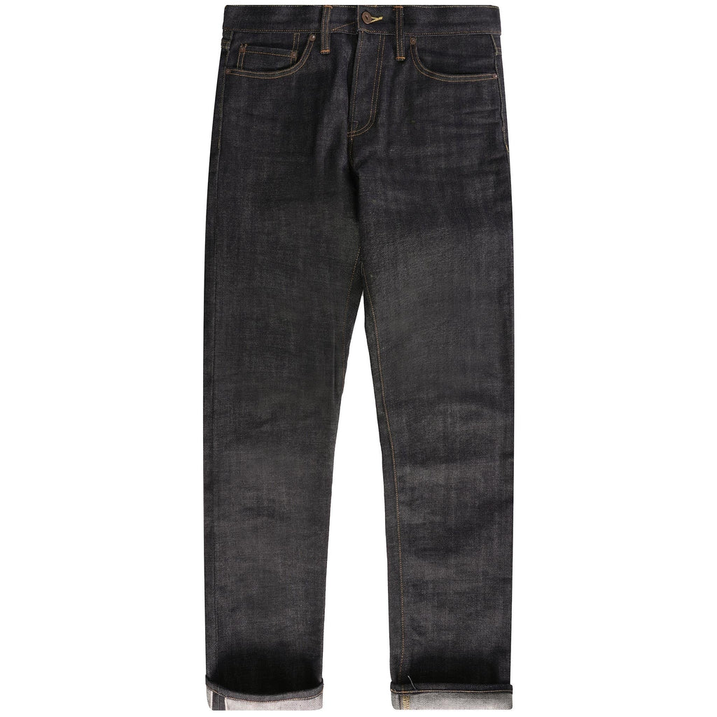 Full view of a pair of dark wash selvedge denim jeans with cuffed hems.