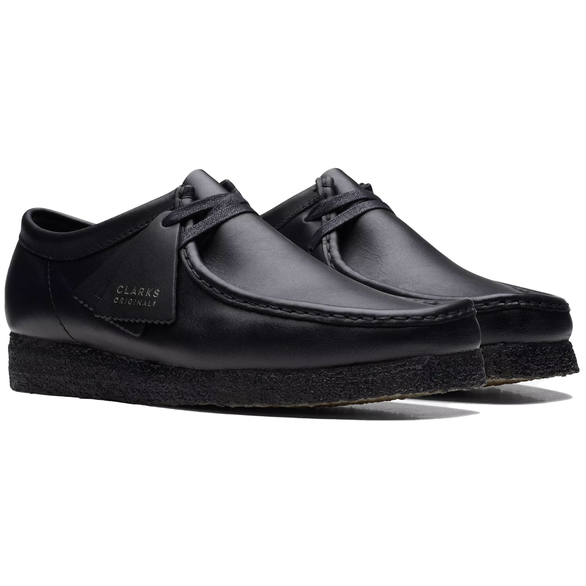 Pair of black leather Clarks Originals Wallabee shoes on a white background.